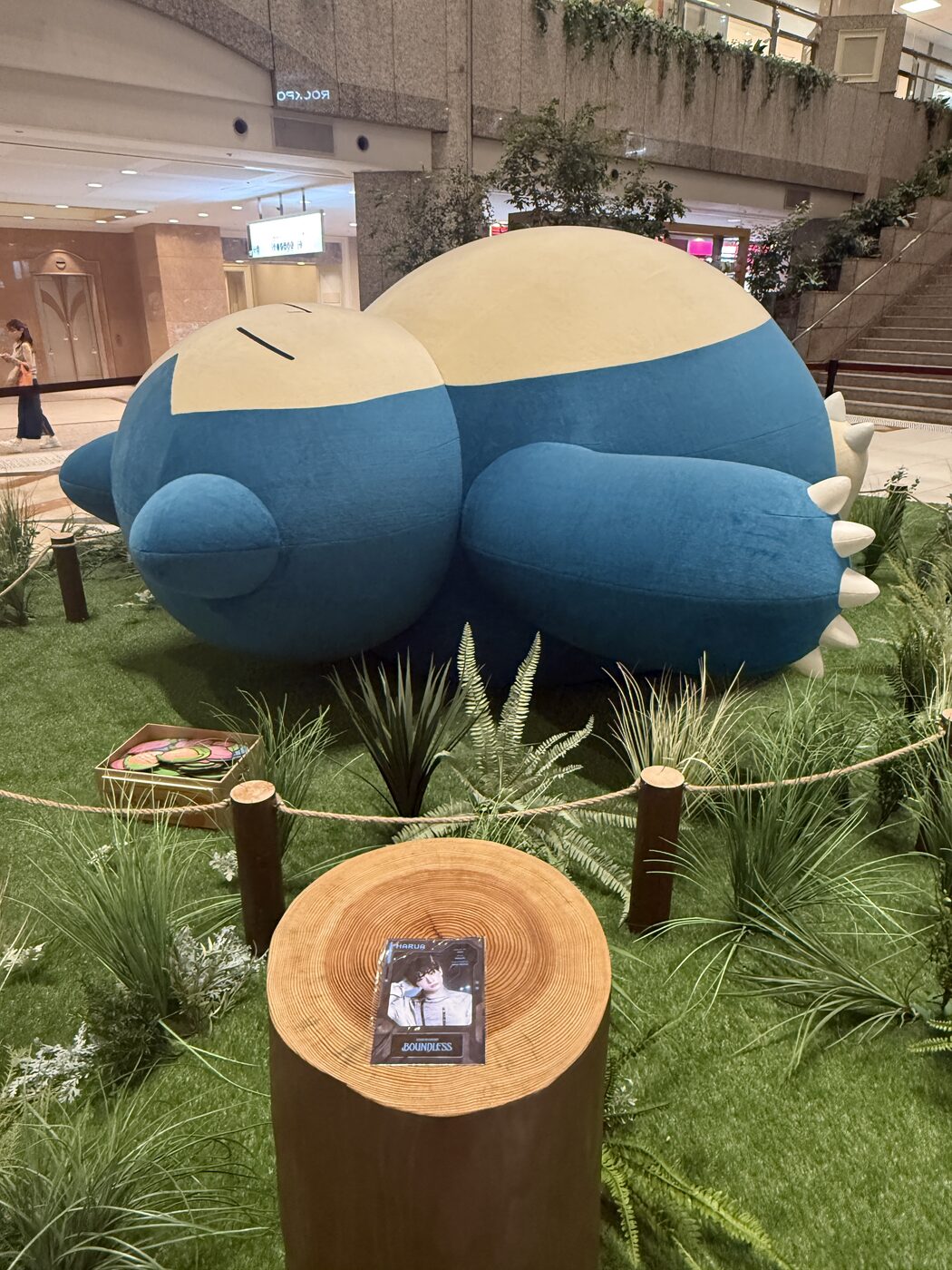 A roughly three-metre sleeping Snorlax on a grass installation in Landmark Plaza
