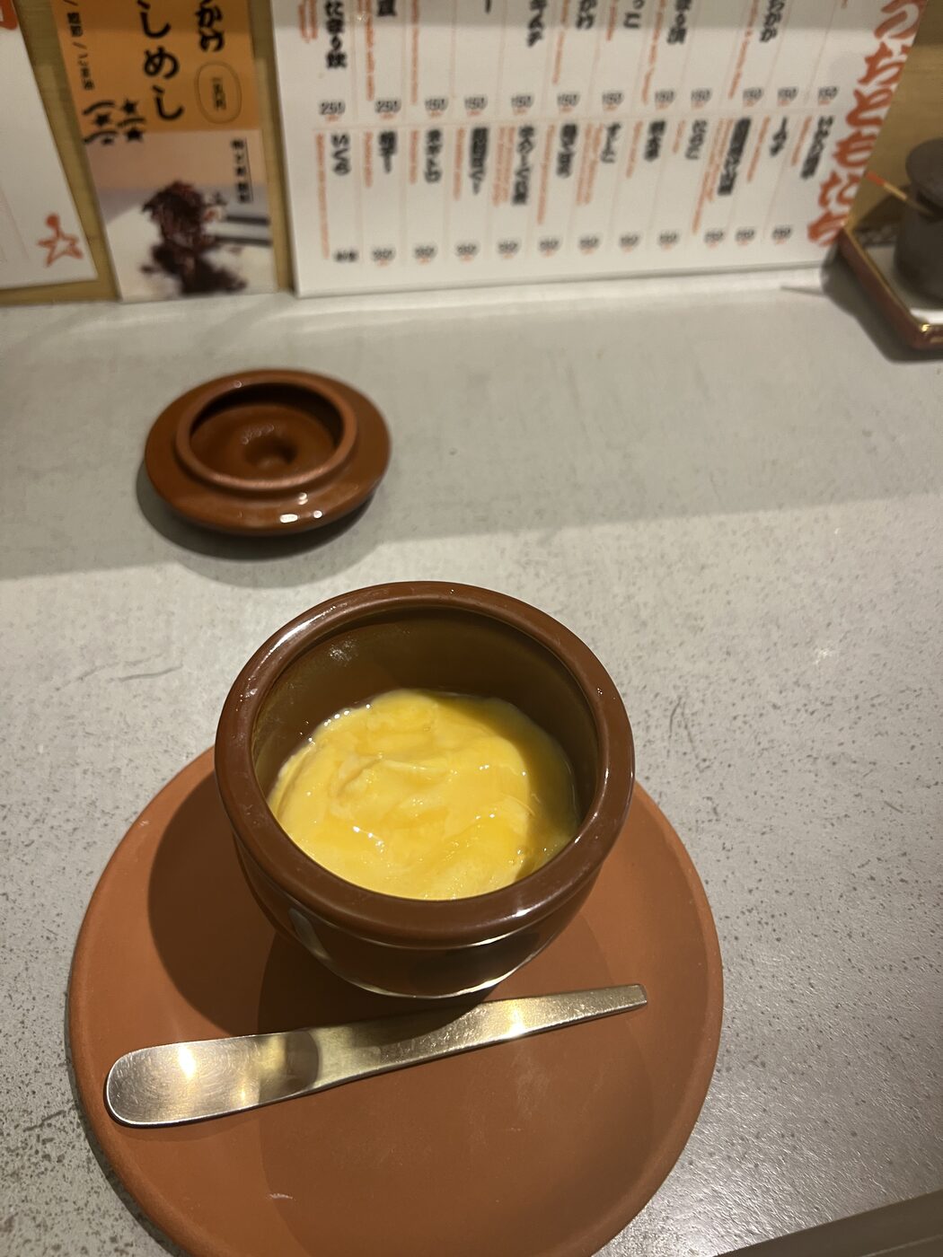A fluffy egg served in a small clay pot