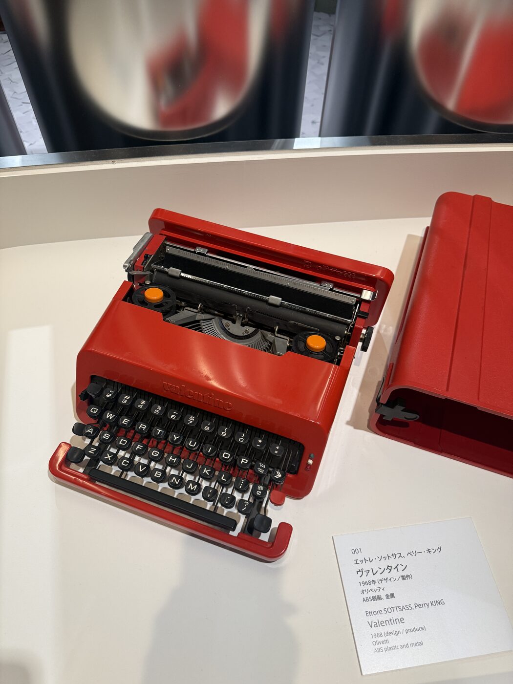 The cherry-red Olivetti Valentine typewriter on a plinth