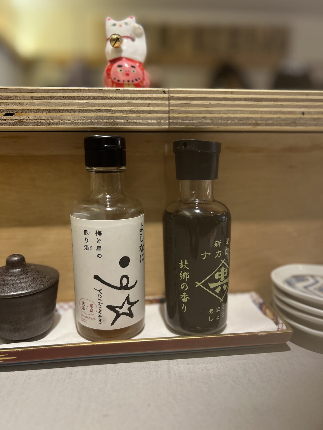 Seasonings on the counter beside a small lucky-god figurine