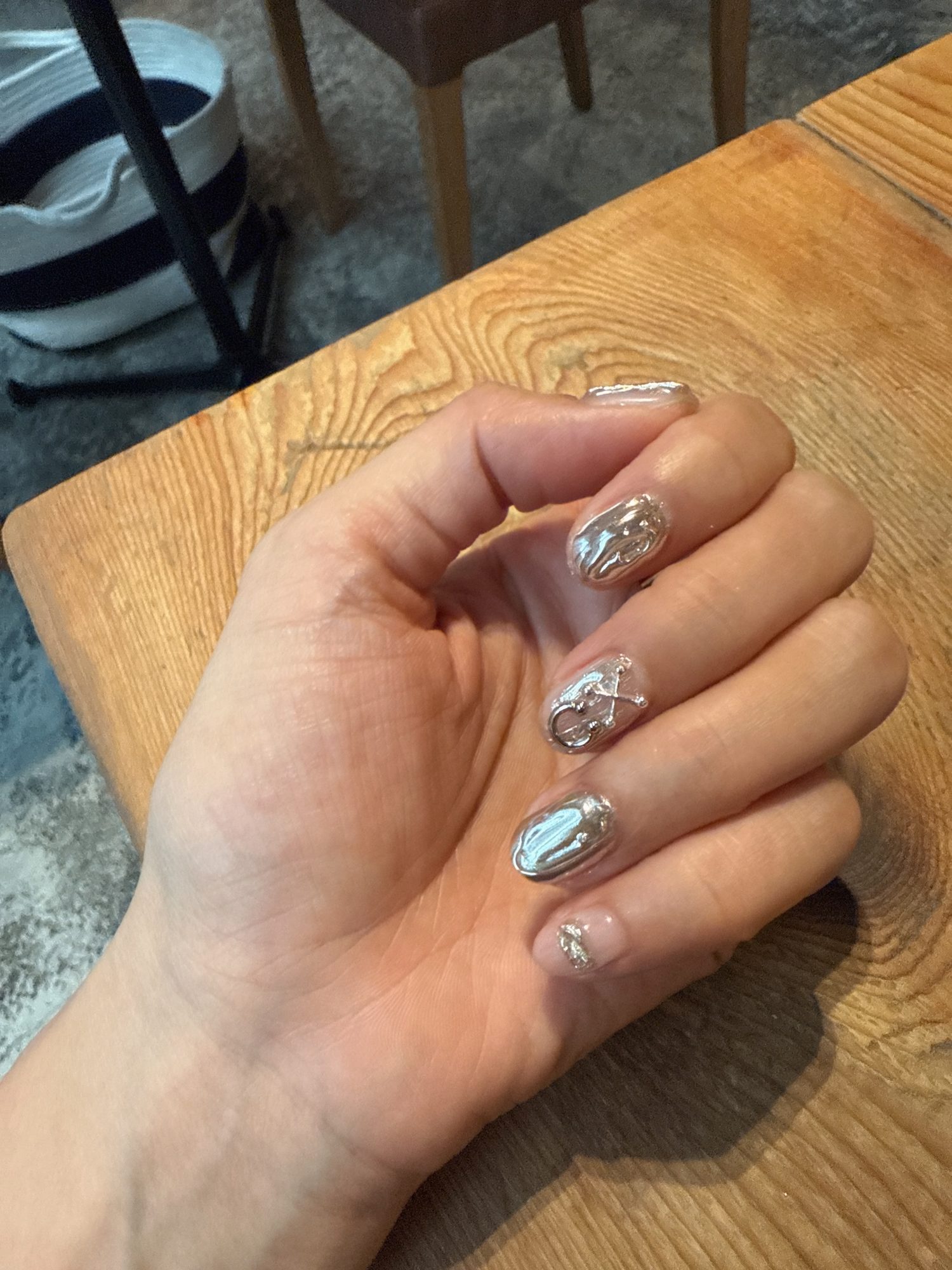 A finished Tokyo gel manicure — chrome and hand-painted detail